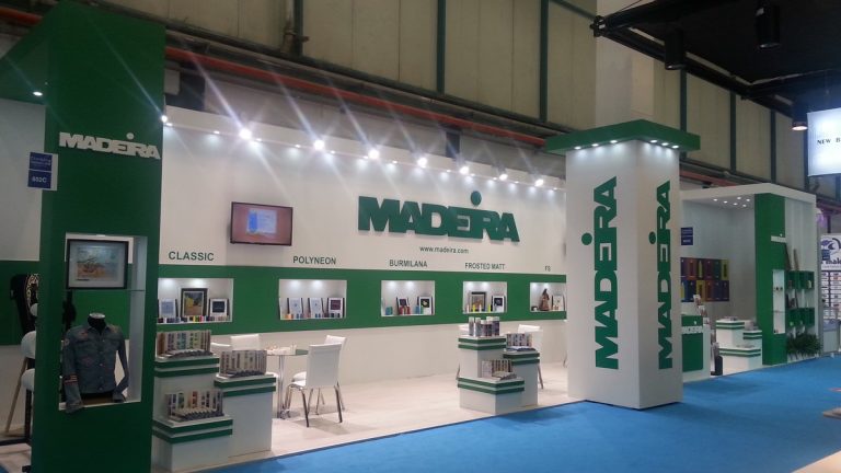 Exhibition Stand Builder in Istanbul 6 Green and white exhibition stand with display niches and a corner tower, built by Creostand